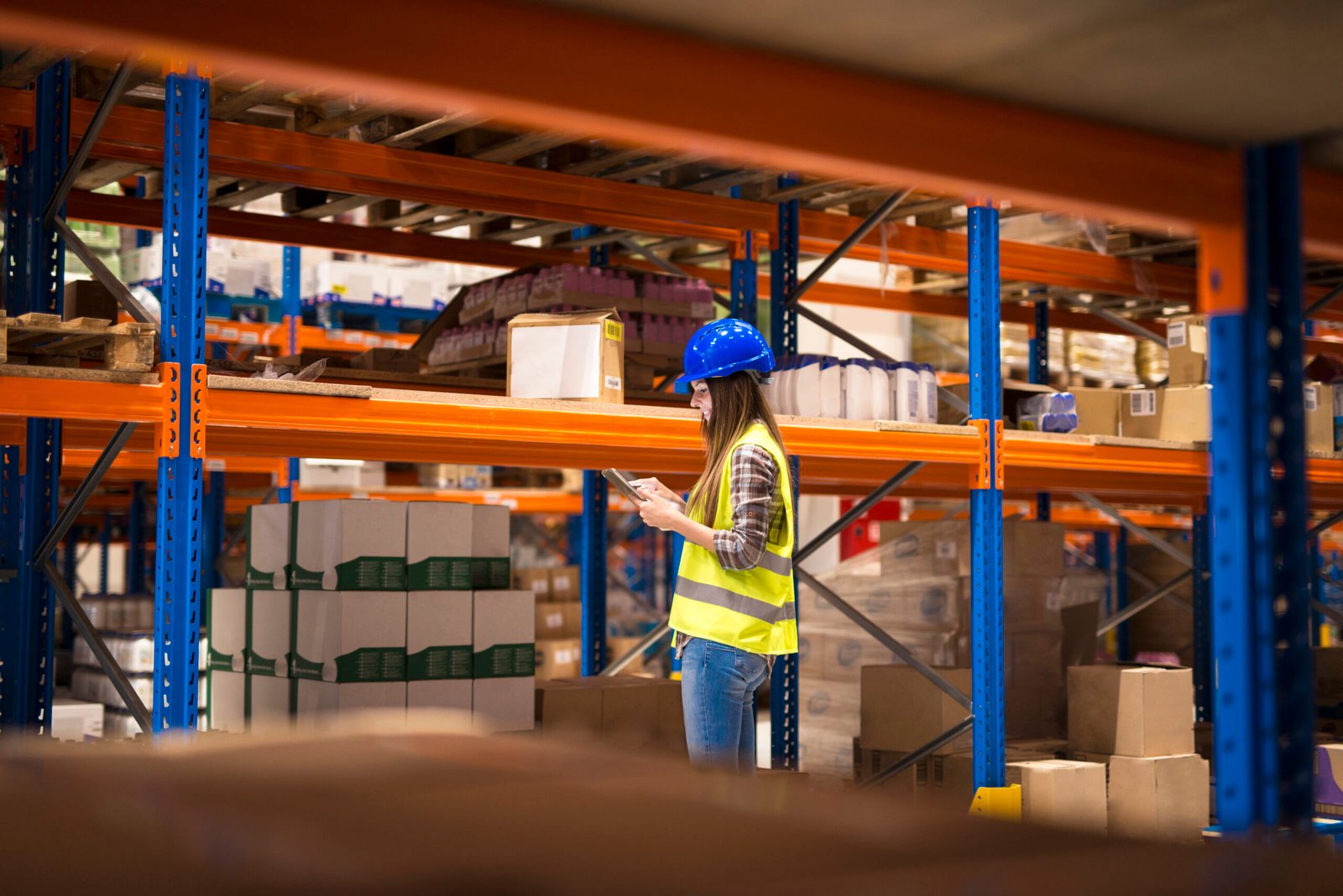 Warehouse staff monitoring inventory with industrial pallet racking and steel racking systems